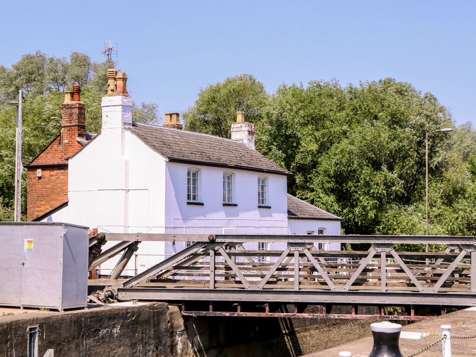 A house and bridge near trees at The Lock House in Gloucester