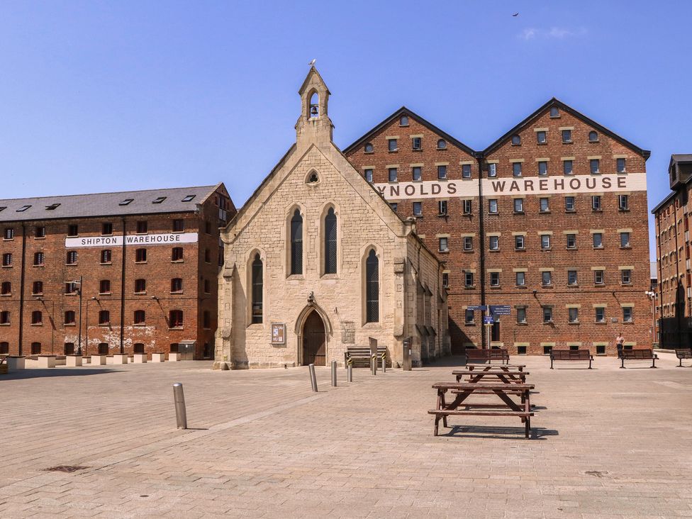 An outdoor area with warehouses and benches at The Lock House in Gloucester