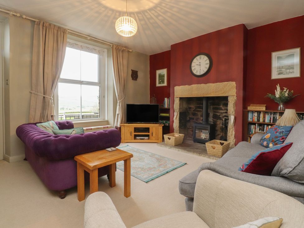 A living room with a sofa and television at Canalside Cottage Farnhill near Skipton