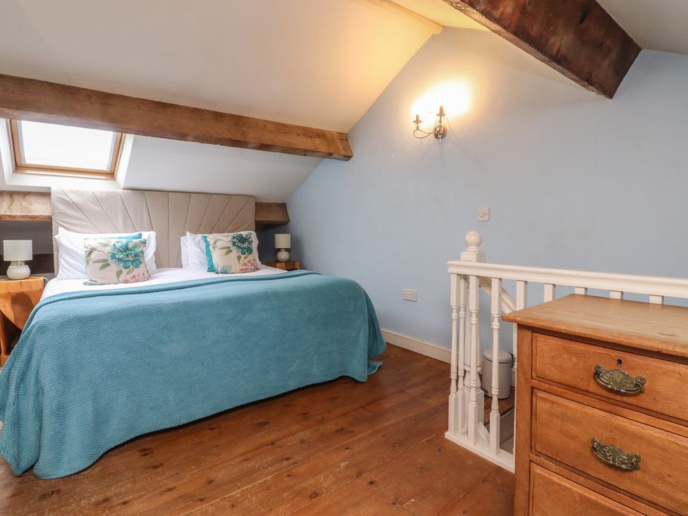 A bedroom with a bed and a chest of drawers at Canalside Cottage in Farnhill near Skipton