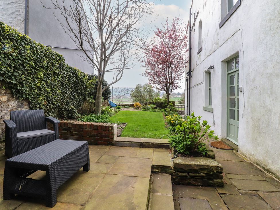 A garden with seating and plants at Canalside Cottage in Farnhill near Skipton