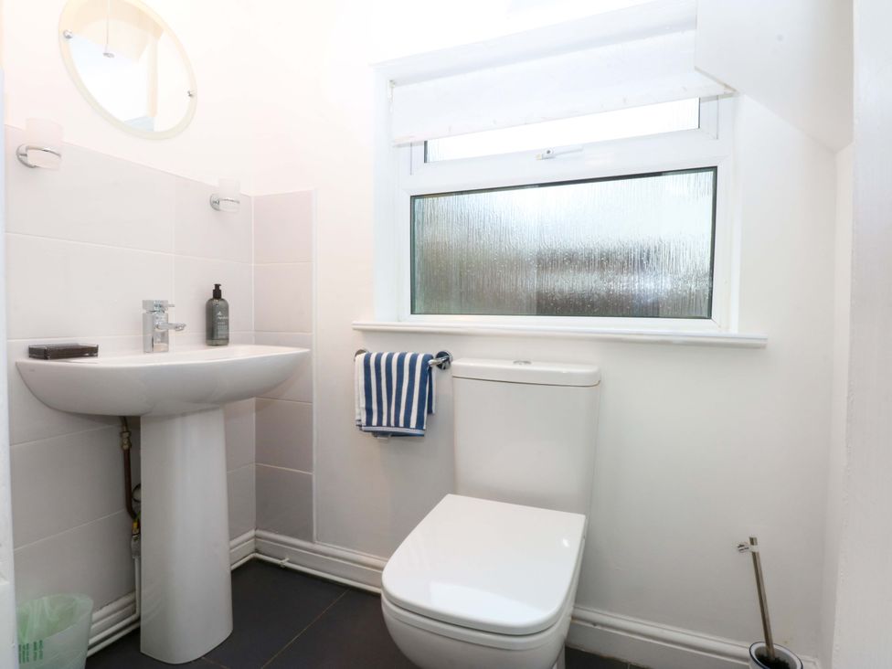 A bathroom with a sink and toilet at Min Y Traeth Bull Bay