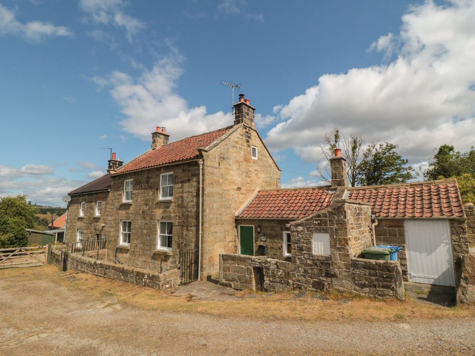 An outdoor view of a cottage with a driveway at 1 Brow Cottages in Green End near Goathland