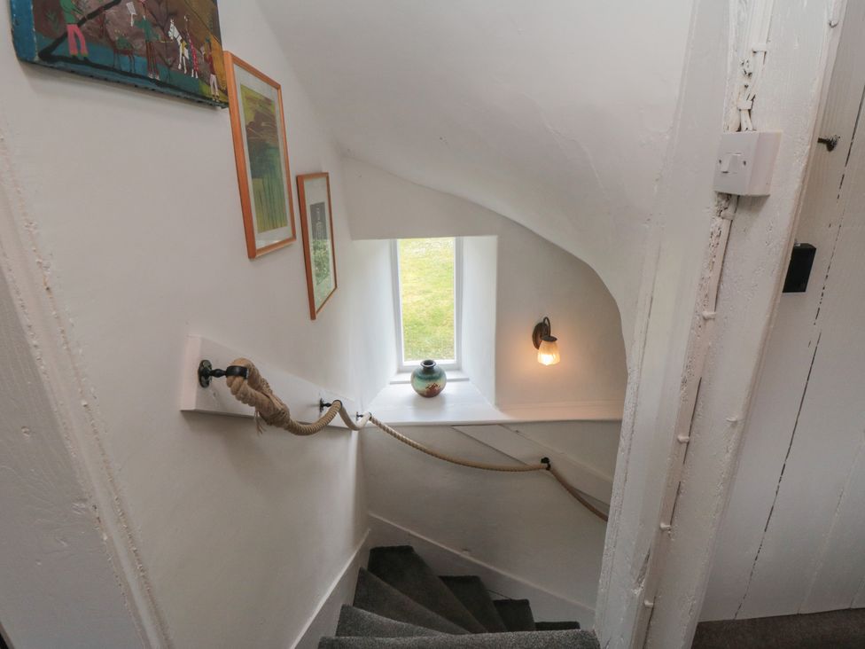 A staircase with wall art and a window at 1 Brow Cottages Green End near Goathland
