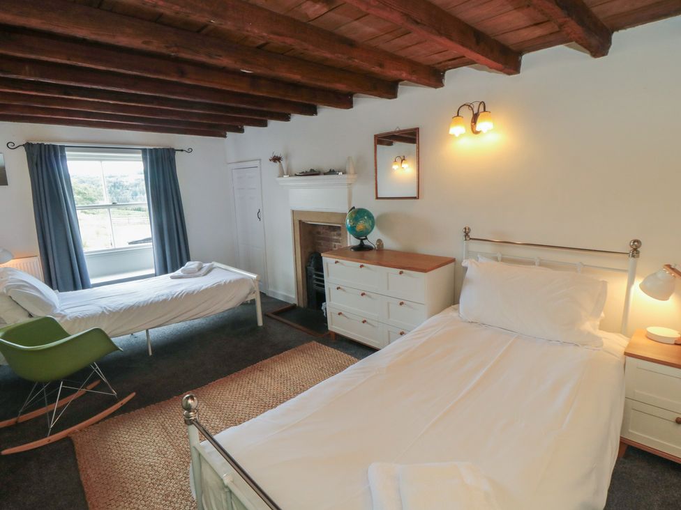 A bedroom with two beds and a dresser at 1 Brow Cottages in Green End near Goathland