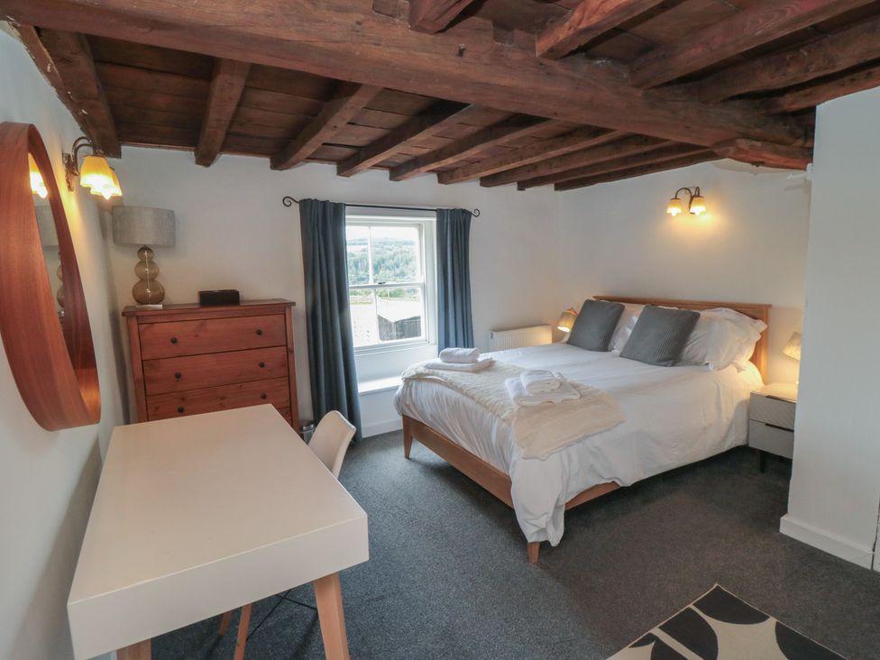 A bedroom with a bed, desk, and dresser at 1 Brow Cottages Green End near Goathland