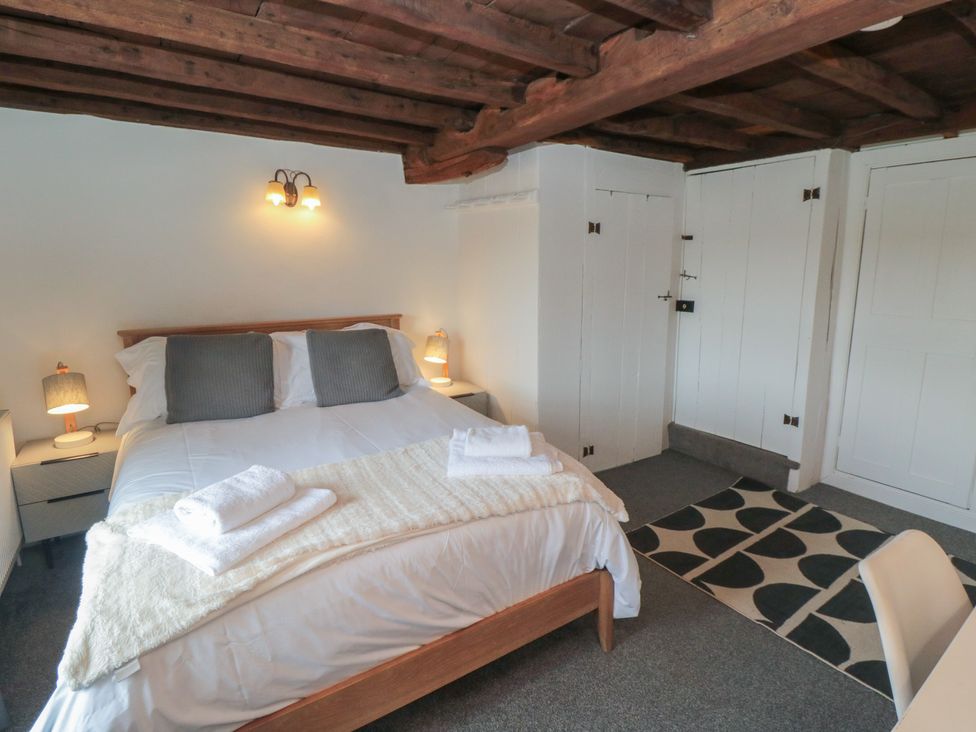 A bedroom with a bed and bedside tables at 1 Brow Cottages Green End near Goathland