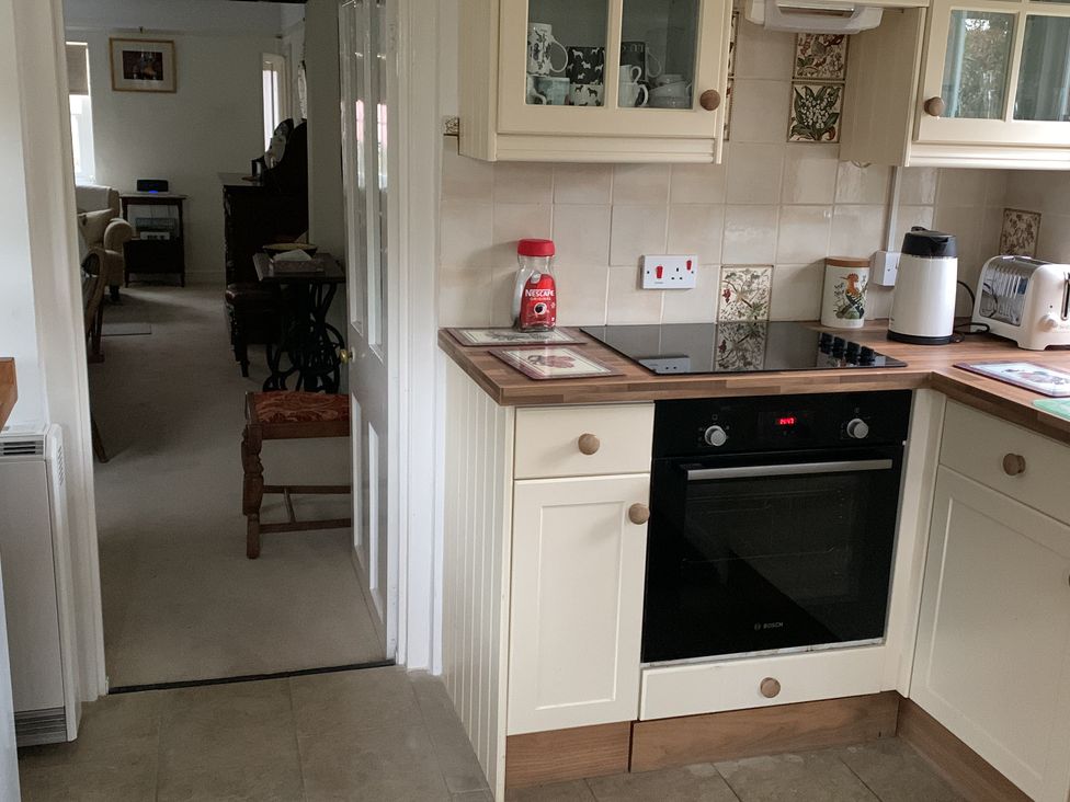 A kitchen with an oven and cabinets at 28 Oxborough