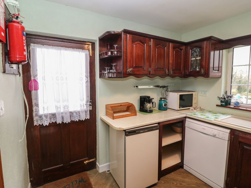 A kitchen with appliances and cabinets at The Farmhouse in Dunmanway, County Cork