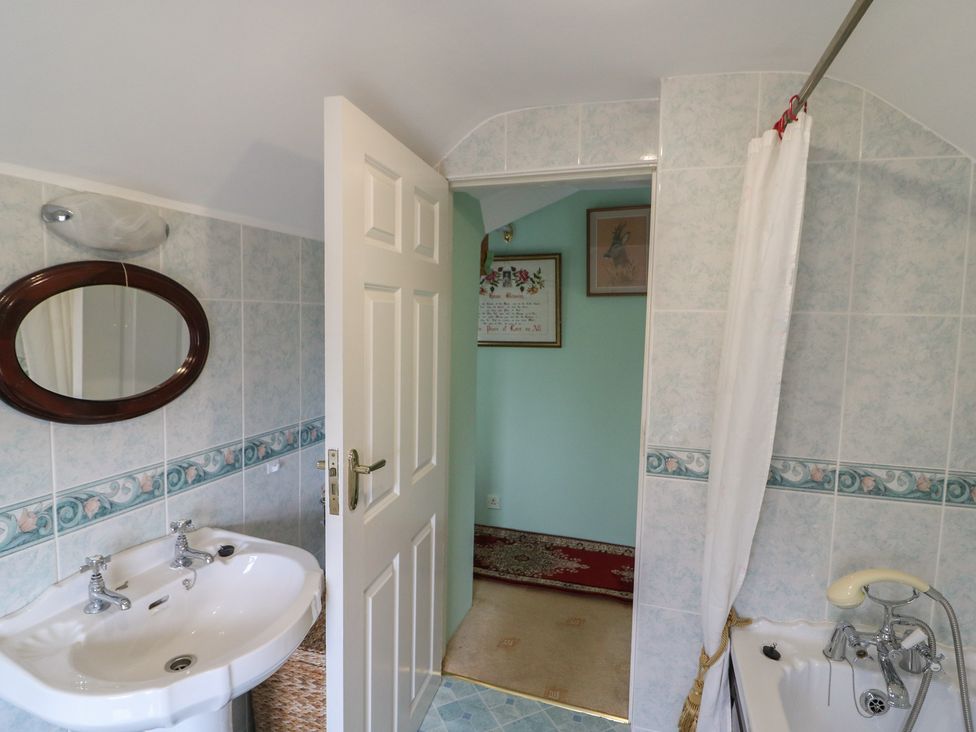 A bathroom with a wash basin and a bathtub at The Farmhouse in Dunmanway, County Cork