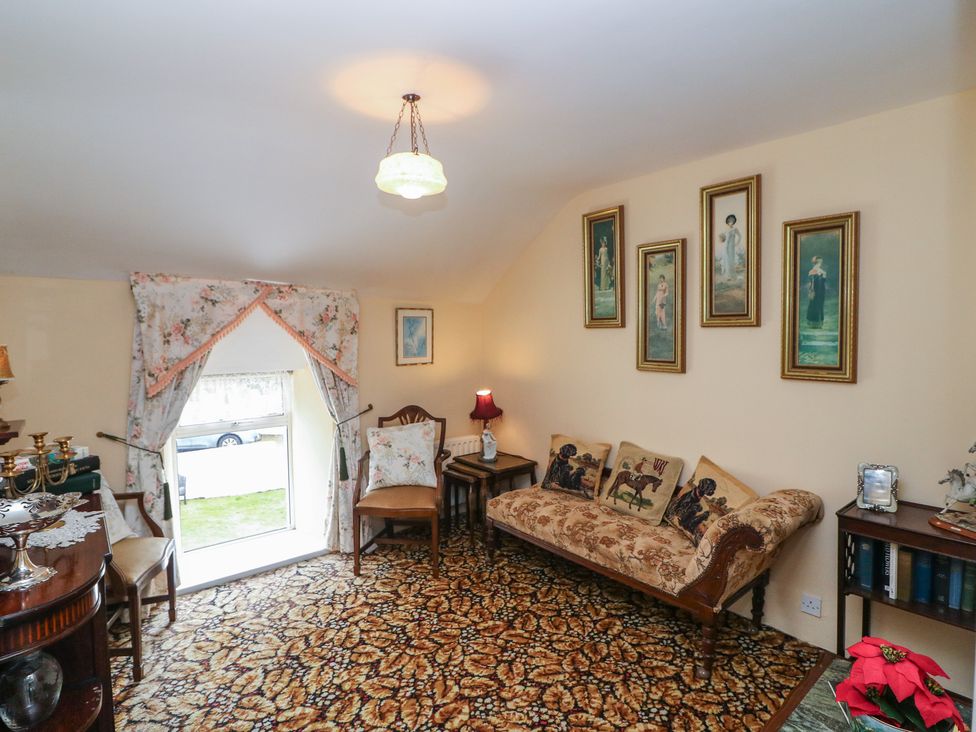A living room with a sofa and armchair at The Farmhouse in Dunmanway, County Cork