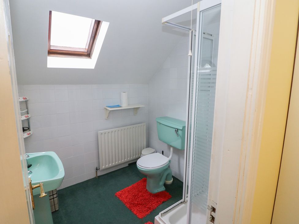 A bathroom with a shower, toilet and sink at The Farmhouse in Dunmanway, County Cork