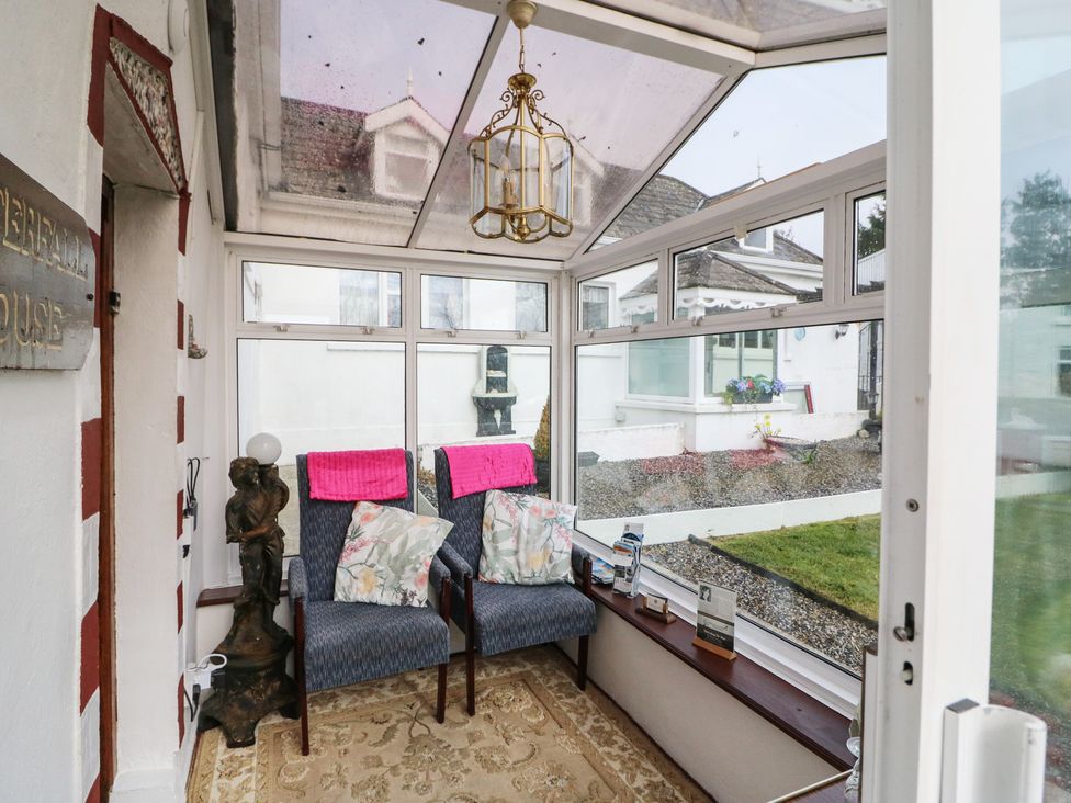 A conservatory with seating and decorative features at The Farmhouse in Dunmanway, County Cork