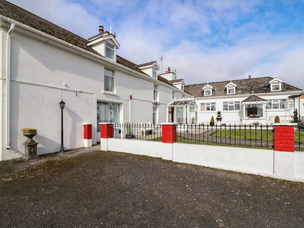 An outdoor area with a building and fence at The Farmhouse in Dunmanway, County Cork