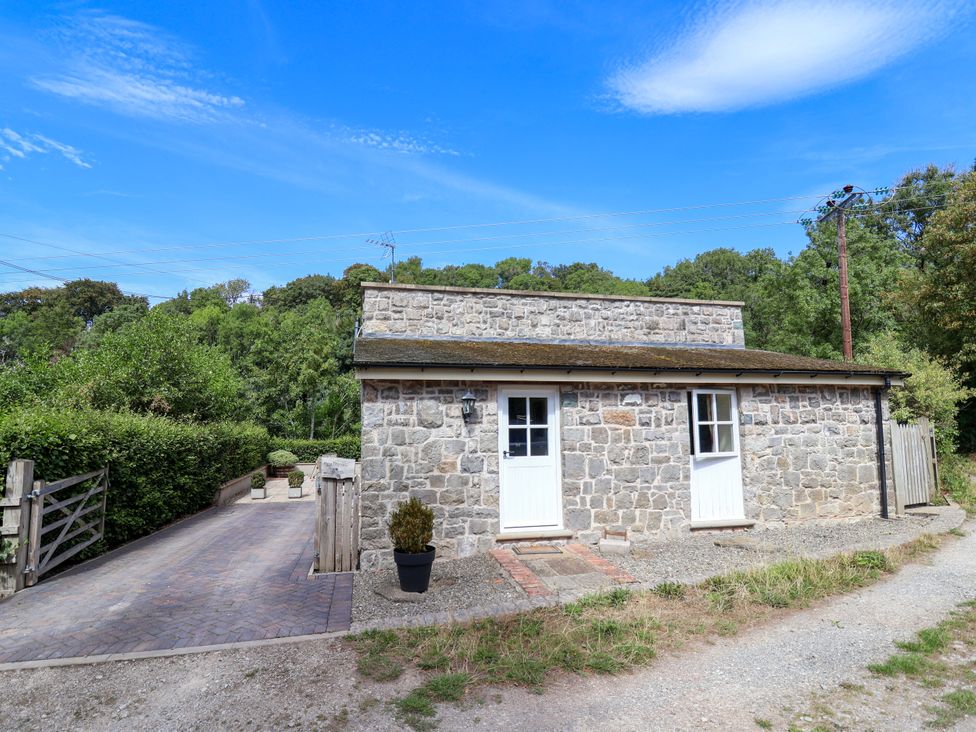 A stone building with doors and windows at The Lambing Shed in Dyserth near Prestatyn