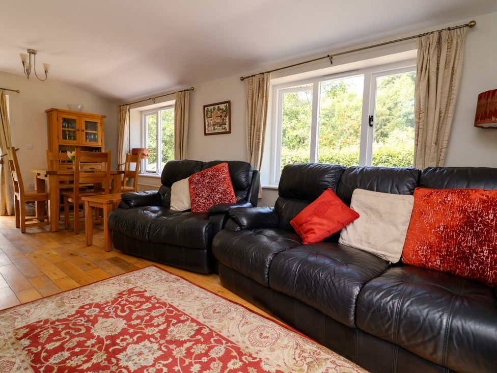 A living room with a sofa and dining table at The Lambing Shed Dyserth near Prestatyn