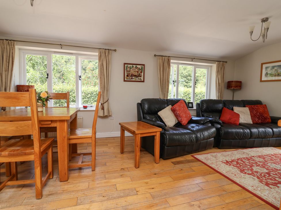 A living room with a table and chairs alongside a sofa at The Lambing Shed Dyserth near Prestatyn