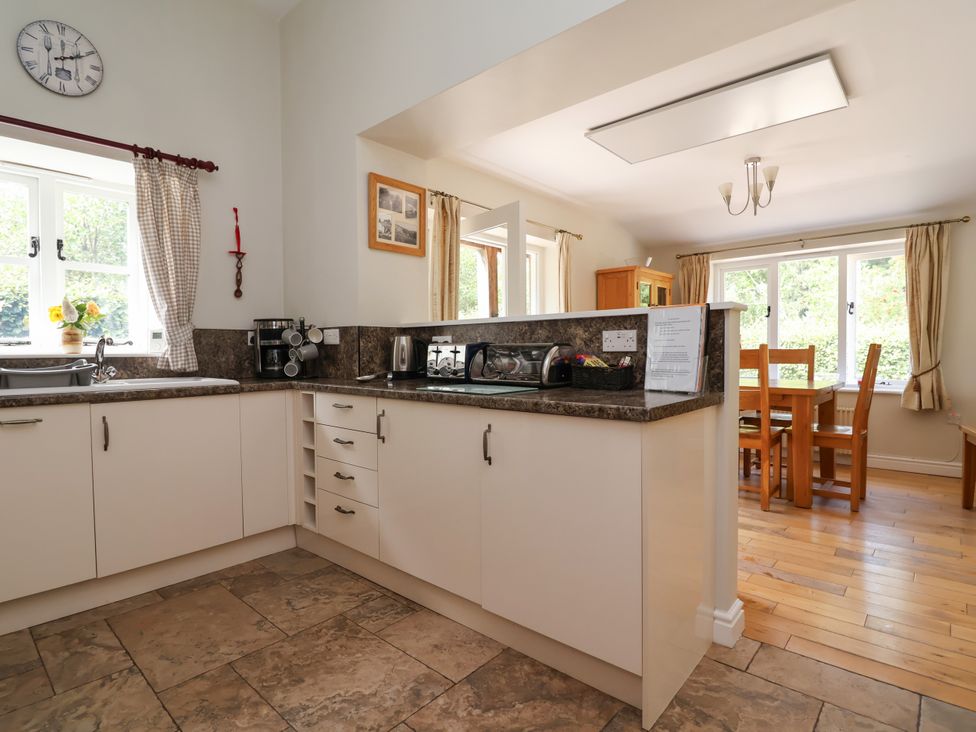 A kitchen with appliances and dining area at The Lambing Shed in Dyserth near Prestatyn