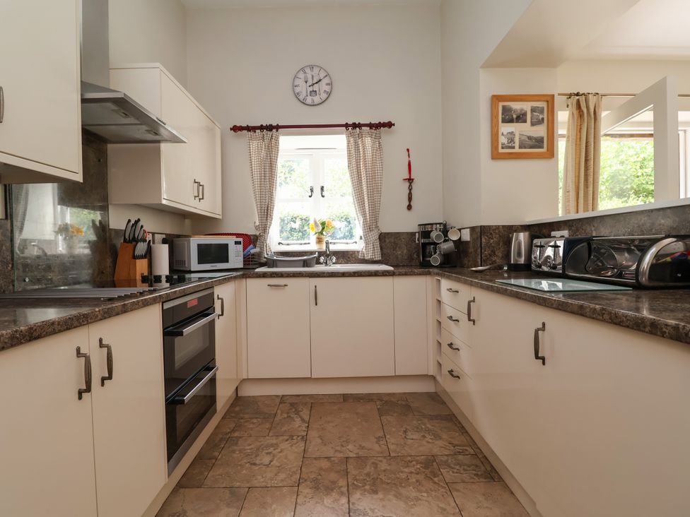 A kitchen with oven microwave and sink at The Lambing Shed near Dyserth