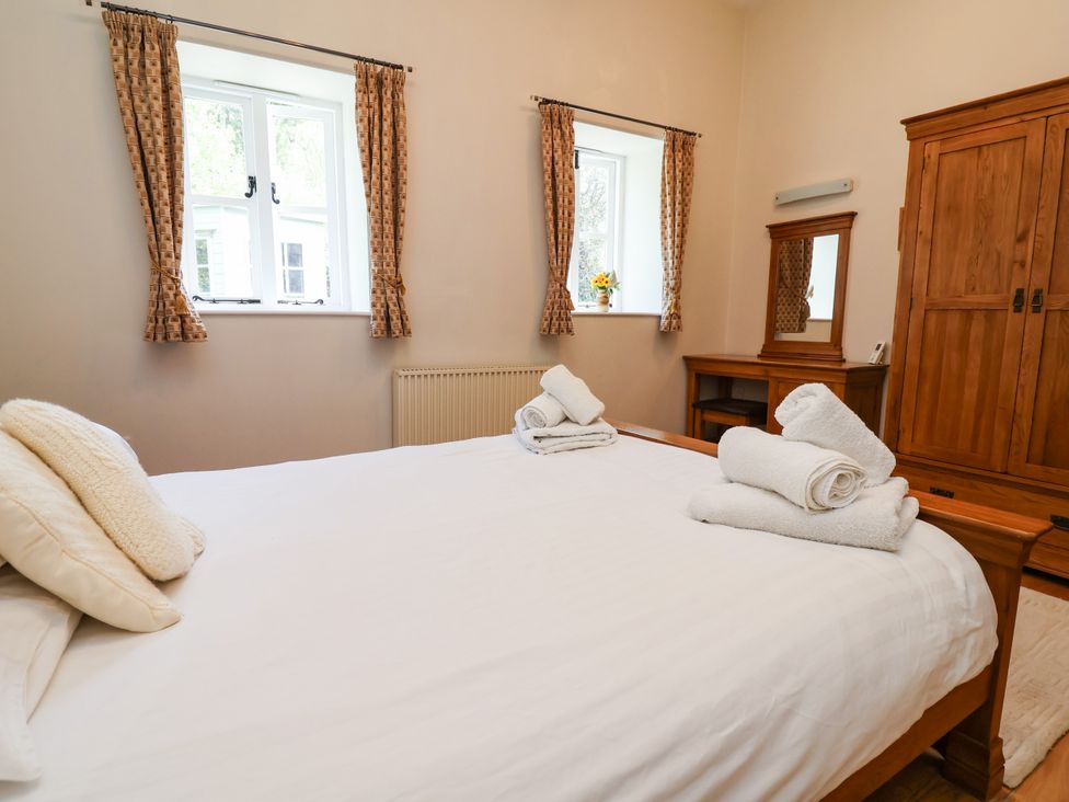 A bedroom with a bed and a dresser at The Lambing Shed Dyserth near Prestatyn