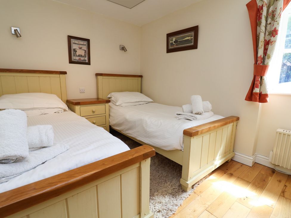 A bedroom with two single beds and a drawer at The Lambing Shed in Dyserth near Prestatyn