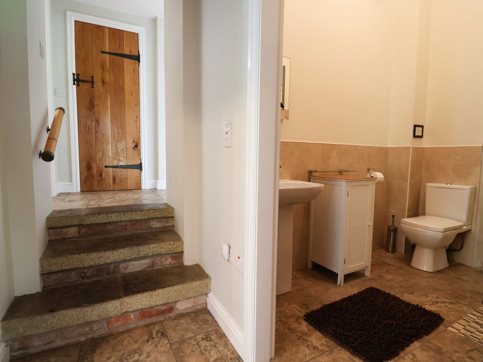 A bathroom with sink and toilet at The Lambing Shed Dyserth near Prestatyn