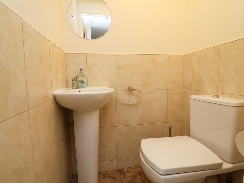 A bathroom with a sink and toilet at The Lambing Shed Dyserth near Prestatyn