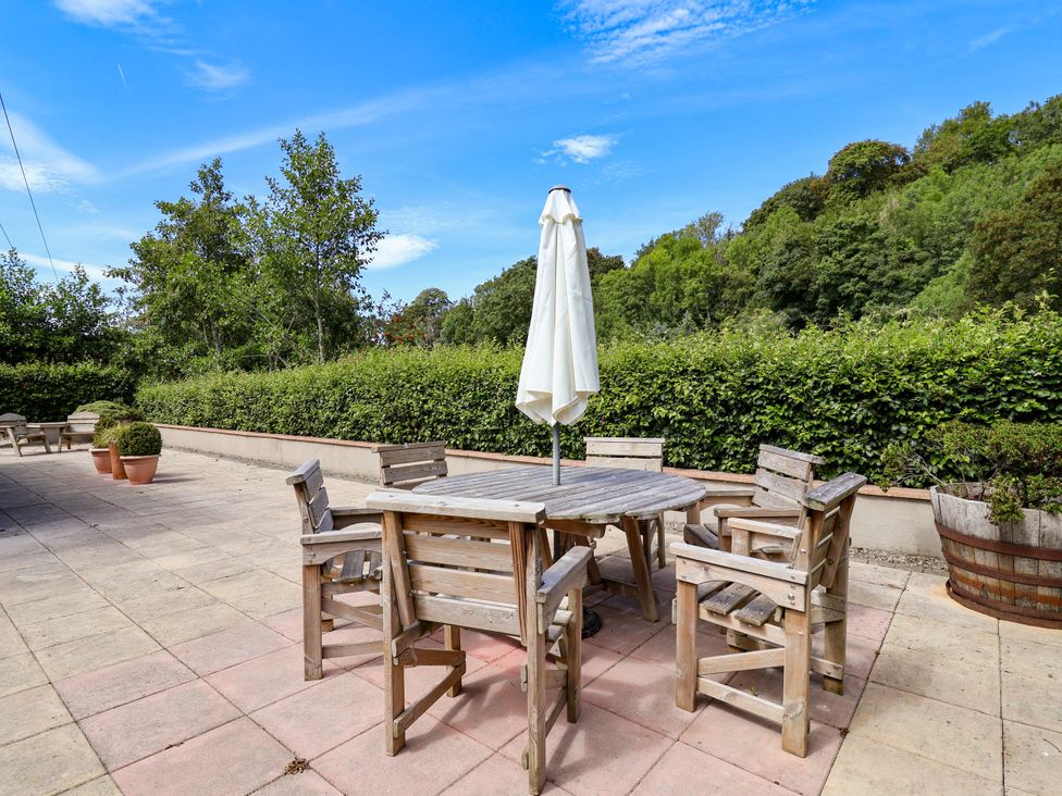 An outdoor seating area with a table and chairs at The Lambing Shed Dyserth near Prestatyn