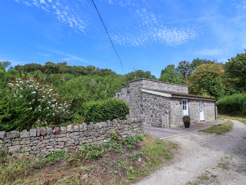 A stone building with a pathway and plants at The Lambing Shed Dyserth near Prestatyn