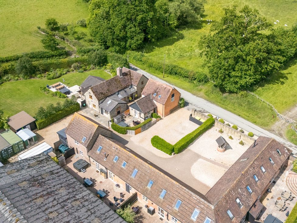 An outdoor view of a house and garden at The Olde Cowshed in Westhope near Church Stretton