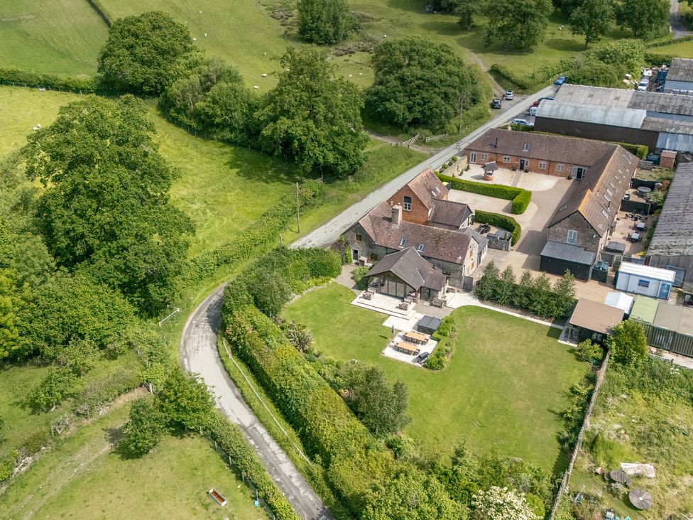 An outdoor view of a house and garden at The Olde Cowshed in Westhope near Church Stretton