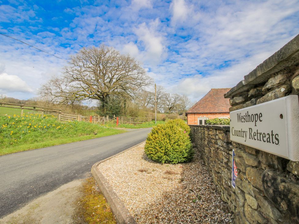 A view of a country road and sign at Westhope Country Retreats near Church Stretton