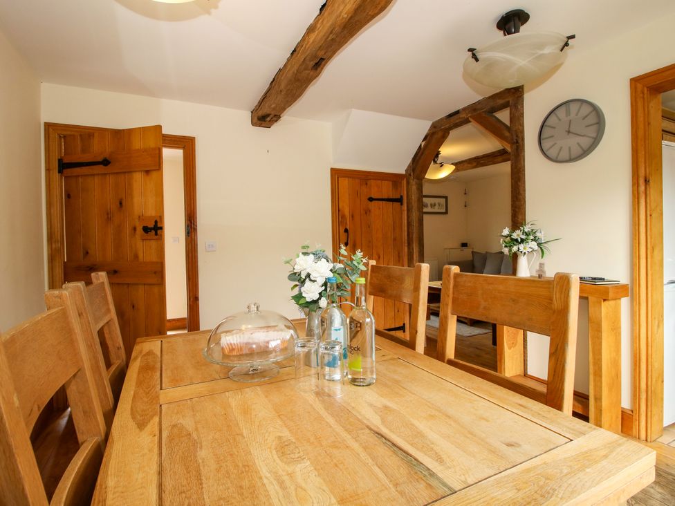 A dining room featuring a table and chairs at The Olde Cowshed near Church Stretton