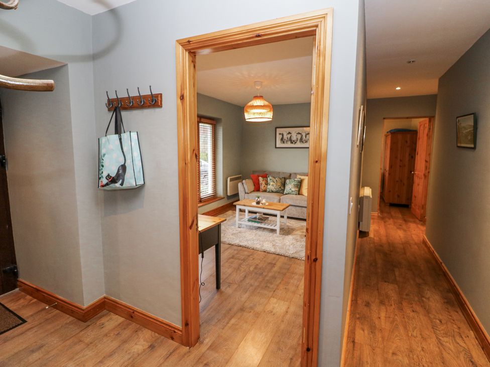 A living room with a sofa and coffee table at Lough Cluhir Cottage, Union Hall, County Cork