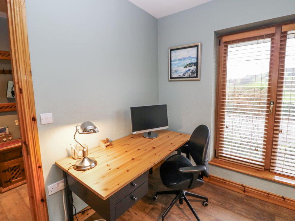 An office with a desk and computer monitor at Lough Cluhir Cottage, Union Hall, County Cork
