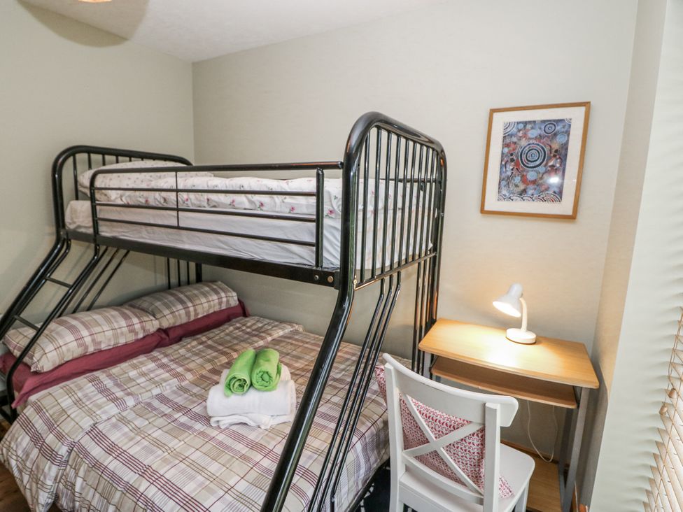 A bedroom with bunk bed and desk at Lough Cluhir Cottage in Union Hall, County Cork