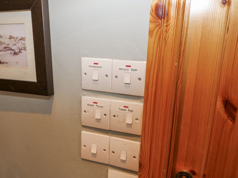 A switch panel for immersion, jacuzzi bath, water pump, and towel rail at Lough Cluhir Cottage in Union Hall, County Cork