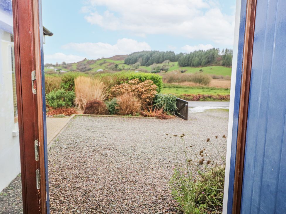 An outdoor area with a view of hills and plants at Lough Cluhir Cottage, Union Hall, County Cork