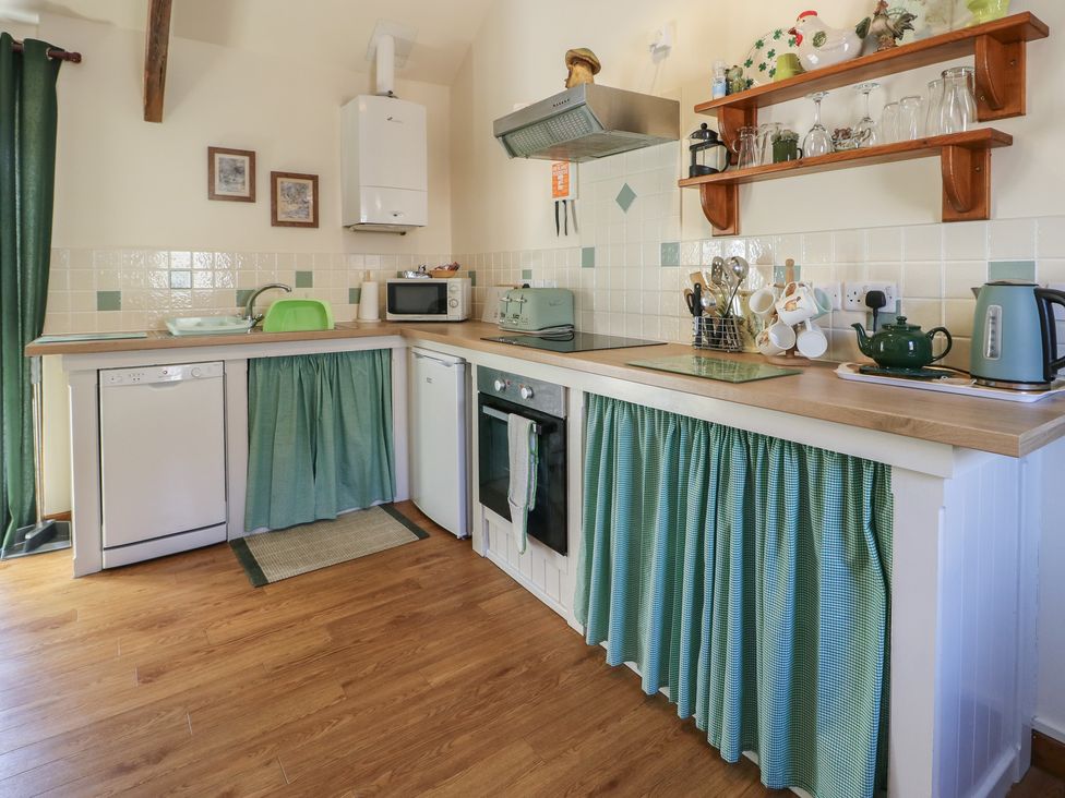 A kitchen with appliances and utensils at Lily Cottage Caeathro near Caernarfon
