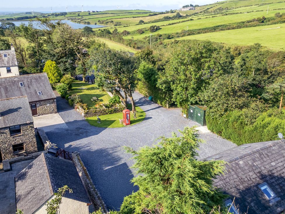 An outdoor area with buildings and a garden at Hill Side Barn in Pennington near Ulverston