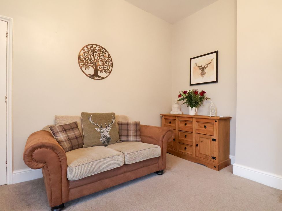 A living room with a sofa and sideboard at The Lodge in Snainton near Scarborough