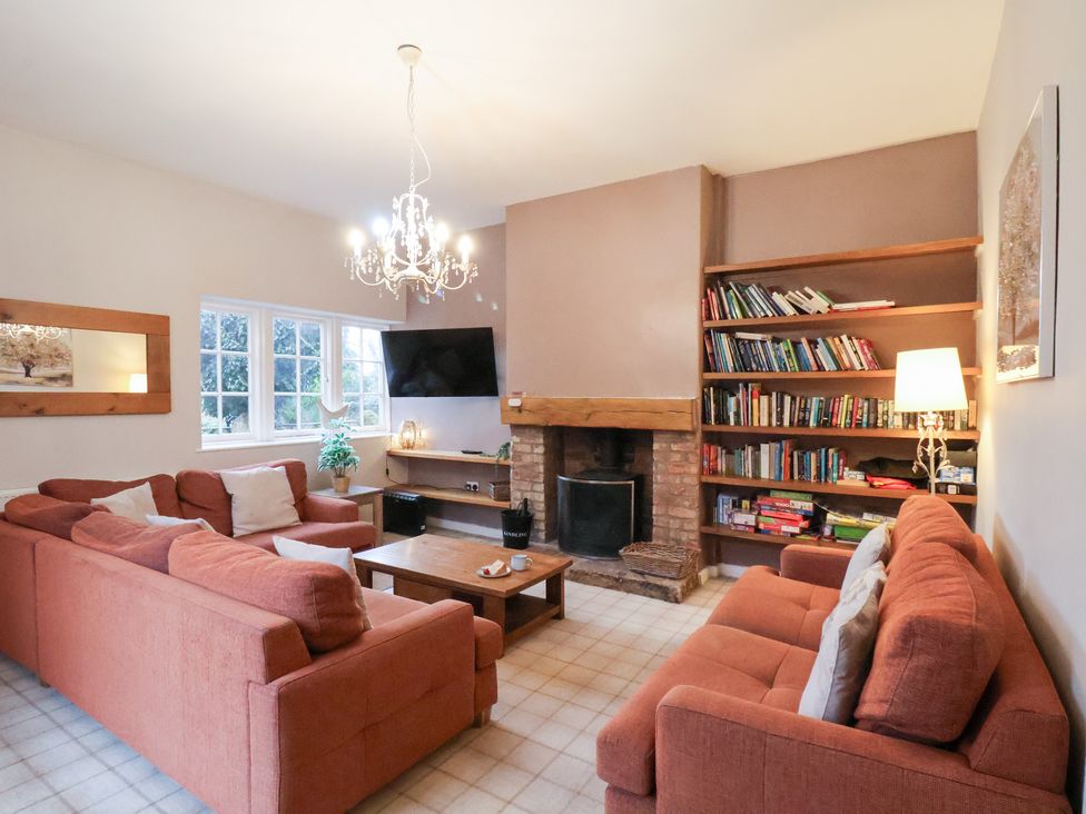 A living room with a sofa and a television at The Lodge in Snainton near Scarborough