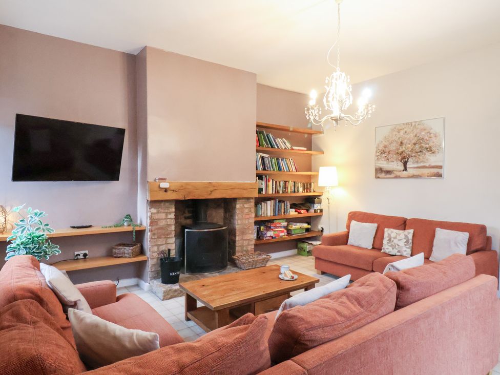 A living room with a television and bookshelf at The Lodge in Snainton near Scarborough