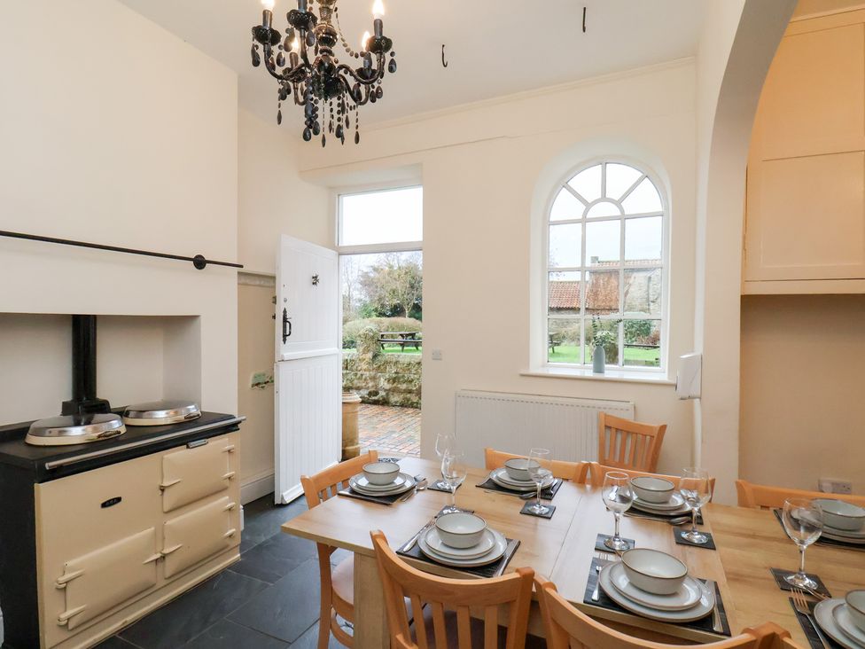 A kitchen with a dining table and chairs at The Lodge in Snainton near Scarborough