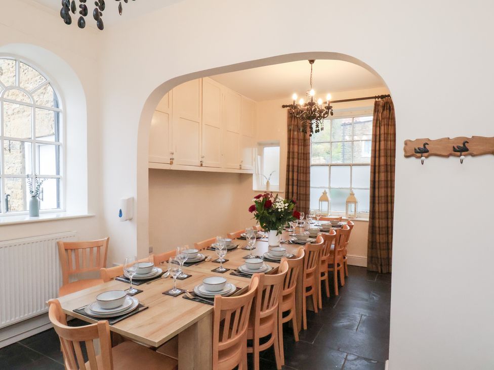 A dining room with a large table and chairs at The Lodge in Snainton near Scarborough