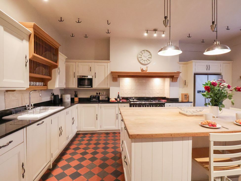 A kitchen with a cooking area, cabinets, and a kitchen island at The Lodge in Snainton near Scarborough