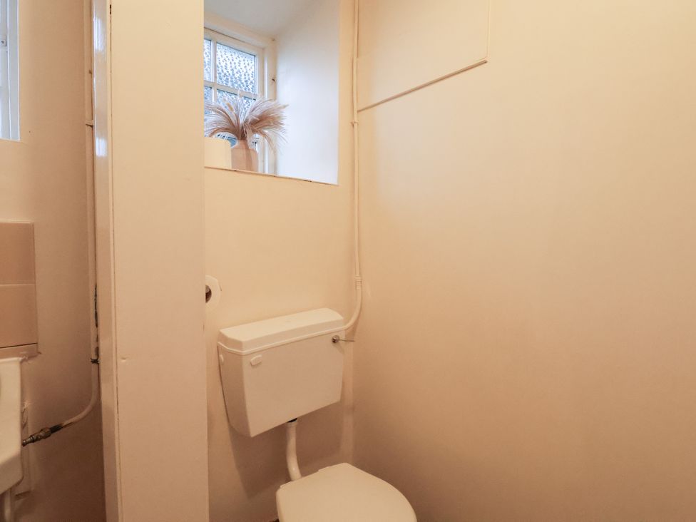 A bathroom with a toilet and a window at The Lodge in Snainton near Scarborough