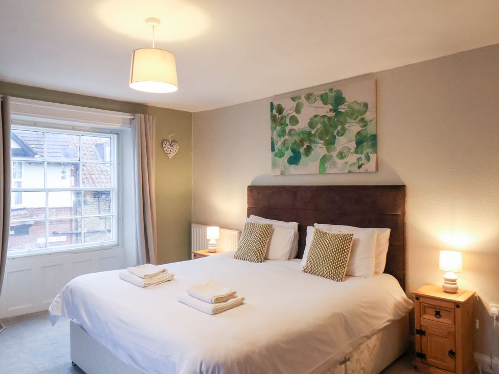 A bedroom with a double bed and bedside tables at The Lodge in Snainton near Scarborough