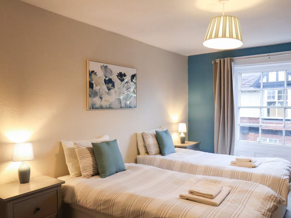 A bedroom with twin beds and a window at The Lodge in Snainton near Scarborough