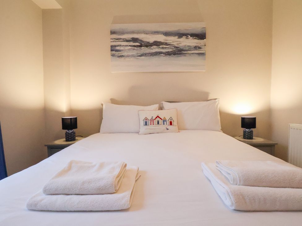 A bedroom with a bed and pillows at The Lodge in Snainton near Scarborough